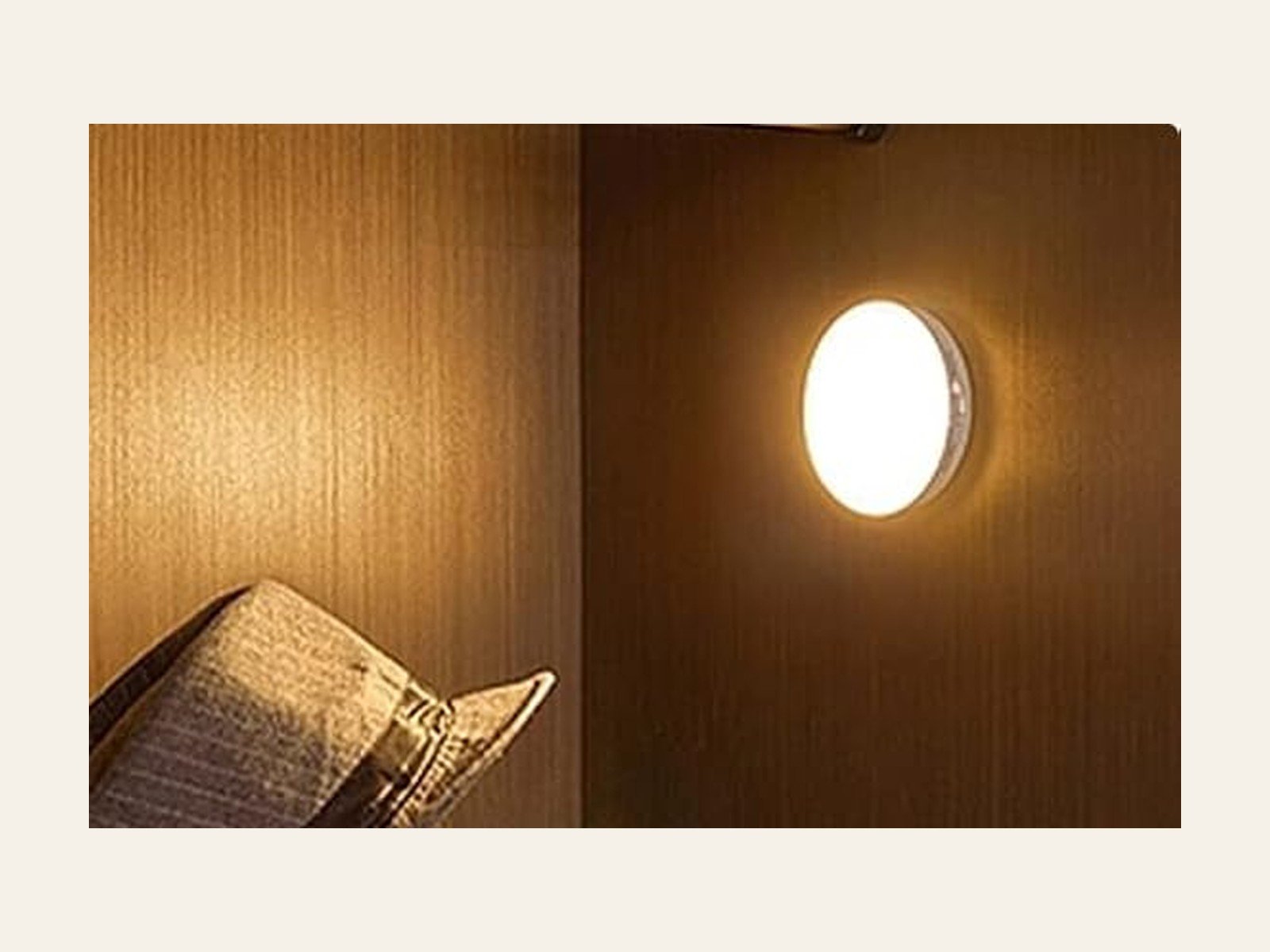 Dark wood of a cupboard, with one small bright light on among the boards.